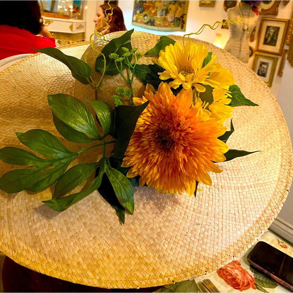 Bright yellow springtime flowers accents on  wide brim straw hat